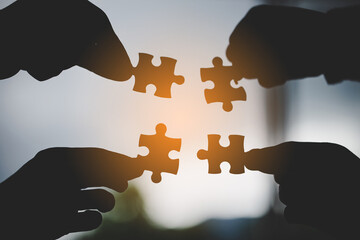 hand of business people connecting jigsaw puzzle