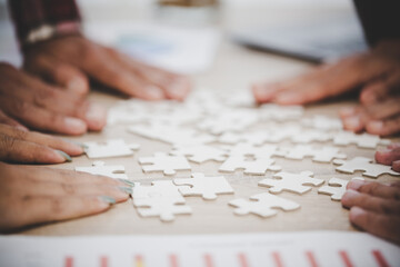 Business people and puzzle on wooden table