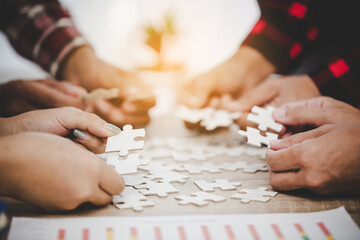 Business people and puzzle on wooden table