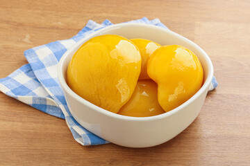 Sweet canned peaches with syrope