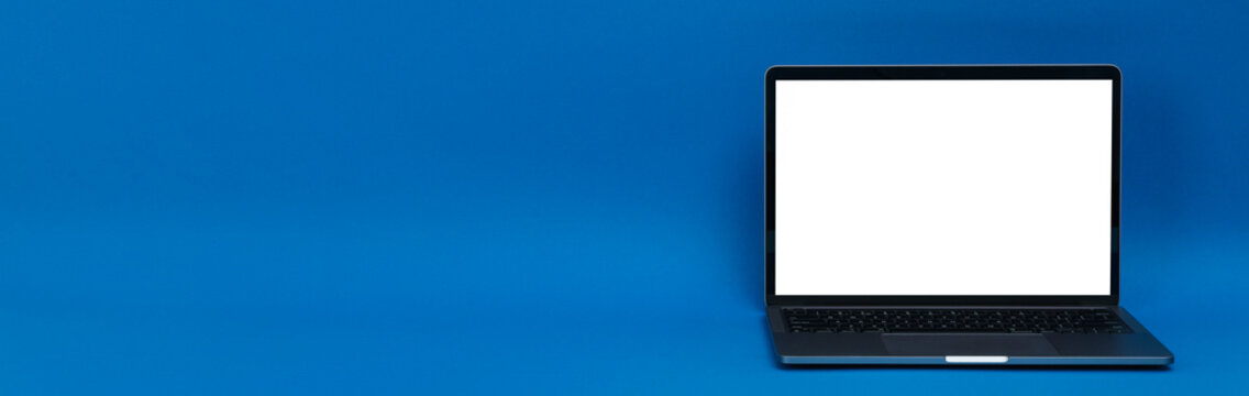 Laptop with blank screen on blue background