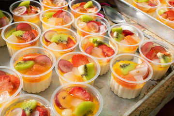 Cup filled with fresh fruits.