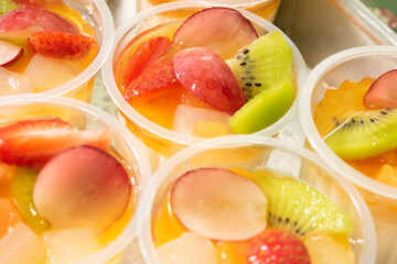 Cup filled with fresh fruits.