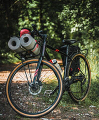 The bicycle is packed with many bags and other equipment ready for adventure and travel. Tourism on a mountain bike. Bike packing adventures in the woods and on the lakes. Baggage rack on the bike.