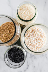 pantry jars with different types of rice including black brown arborio and sushi rice, simple staple ingredients