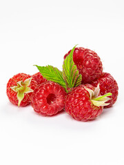 Ripe raspberries with leaves isolated on white background