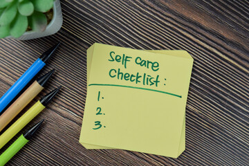 Concept of Self care checklist write on sticky notes isolated on Wooden Table.
