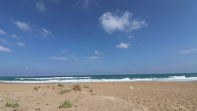 time lapse of light clouds, above the sea waves of Atlit coast in northern Israel