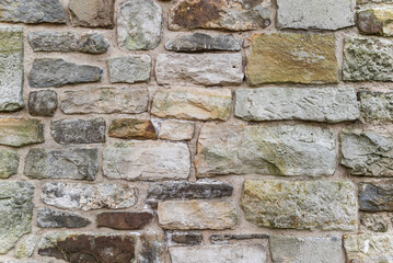 Architectural background texture of a medieval natural stone wall at the old castle Schaumburg, Germany