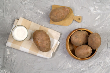 Potato milk in glass and potato. Plant based milk replacer and lactose free.