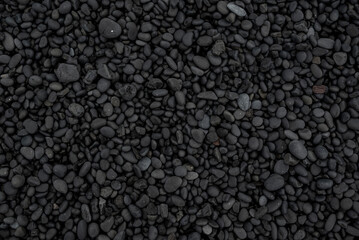 Beautiful black lava stone background texture, full frame shot of the black pebbles at Djúpalónssandur beach, Iceland