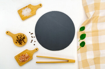 Cooking utensils on a white concrete background. Kitchen frame for food. Black Slate board