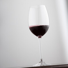 Glass of red wine on white