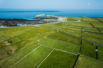 Green grass fields between stone fences of walls. Aerial top down view on meadow. Irish landscape....