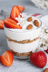 Ricotta dessert with fresh strawberries. Healthy breakfast of yogurt, strawberry and almonds