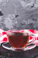 cup of black tea on a black stone background