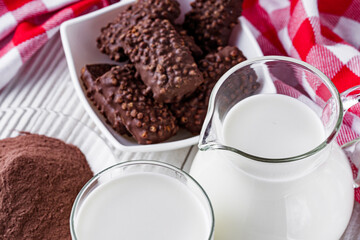 chocolate cocoa milk powder on a white wooden rustic background