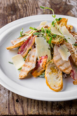 Caesar salad with ham, cheese, bacon