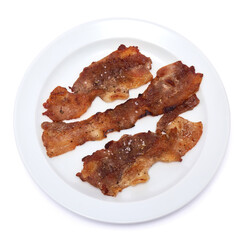 Cooked slices of bacon on white ceramic plate isolated on white background