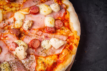 hot delicious traditional italian pizza on a dark stone background