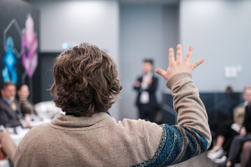 Anonymous man gesturing during presentation in conference hall