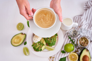 Freshly made poached egg and Avocado toasts on light grey background