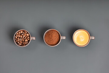 Coffee composition with three cups of coffee on dark background