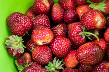 Delicious and healthy strawberries in a green bowl