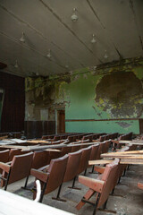 An old assembly hall, an abandoned house, an abandoned building, chairs, armchairs are old.