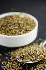 fragrant dried thyme on a dark stone background