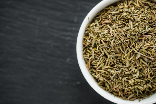 fragrant dried thyme on a dark stone background