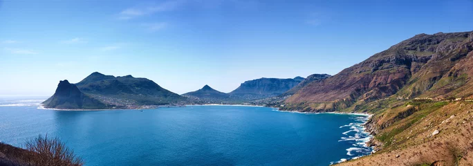 Fototapeten Top landscape view of ocean surrounded by mountains in Hout Bay in Cape Town, South Africa. Popular tourist attraction of hills and calm blue water from above. Exploring nature and the wild © SteenoWac/peopleimages.com