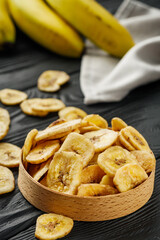 delicious dried banana on a black wooden rustic background