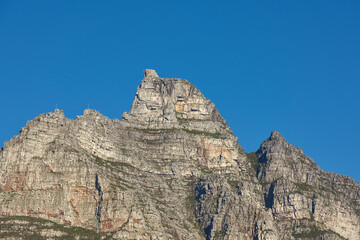 Fototapeta na wymiar Landscape view of Table Mountain in Cape Town, South Africa with blue sky and copy space. Low angle of a steep, rough and rugged famous hiking terrain. Risky and dangerous challenge to climb the peak