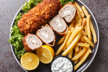 Karadjordjeva steak deep fried rolled veal or pork schnitzel served with fried potatoes with french...