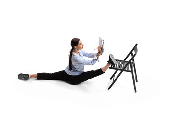 Fototapeta premium Portrait of female office worker sitting on twine and making business notes isolated over white studio background
