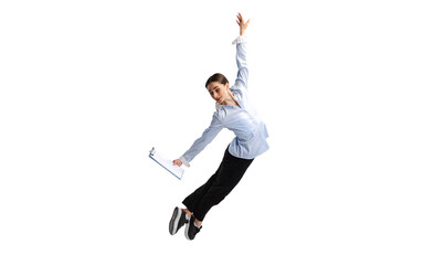 Portrait of young woman, office worker reading project papers in a jump isolated over white studio...