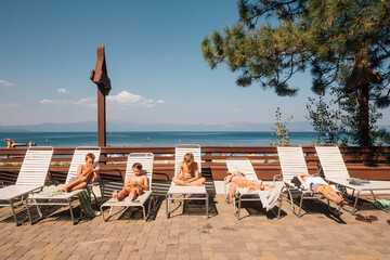 Children sunbathing on sun loungers