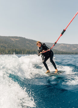 Boy wakeboarding at lake