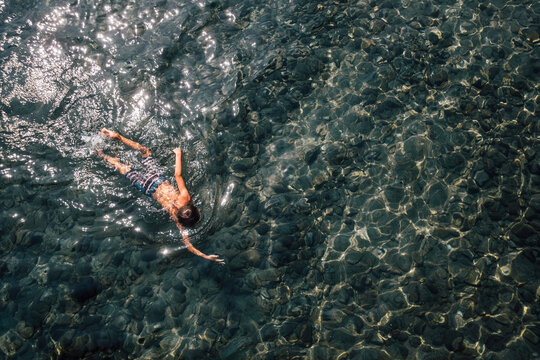 Boy swimming in lake