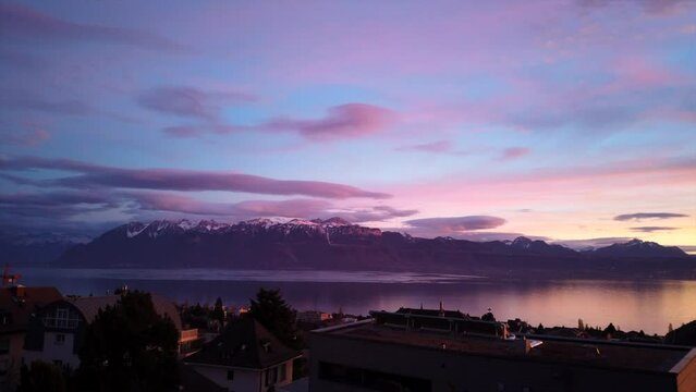 Panoramic motion timelapse of Lake Geneva, colorful evening, passing clouds and sunset. Vaud, Switzerland