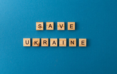 Save Ukraine background. Phrase from wooden letters. Top view words. The phrases is laid out in...