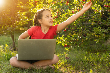 Kids using laptop learning in organic vegetable farmland in raral