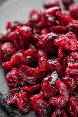dried cranberry berry on a black wooden rustic background