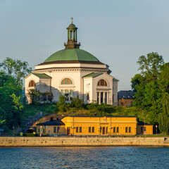 Eric Ericsonhallen concert hall, formerly Skeppsholmen Church until 2009, surrounded by trees. View...