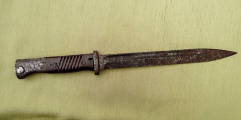 bayonet-knife of the German rifle K-98 of the Second World War against the background of green cloth
