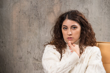 Fototapeta premium Photo of attractive lady sitting in comfy chair and posing