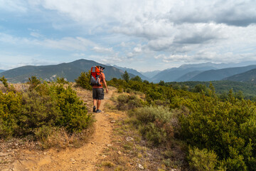 A man on a trek between the villages of Las Latas to Larrede near Sabiñanigo, Pyrenees aragon