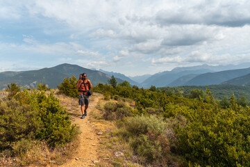 Fototapeta premium A man on a trek between the villages of Las Latas to Larrede near Sabiñanigo, Pyrenees aragon