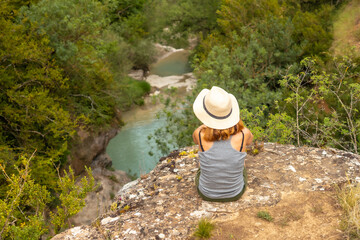 A woman with a hat enjoying the peace of nature in the Pyrenees, Panticosa
